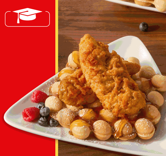 Breaded chicken with berries on a plate. 