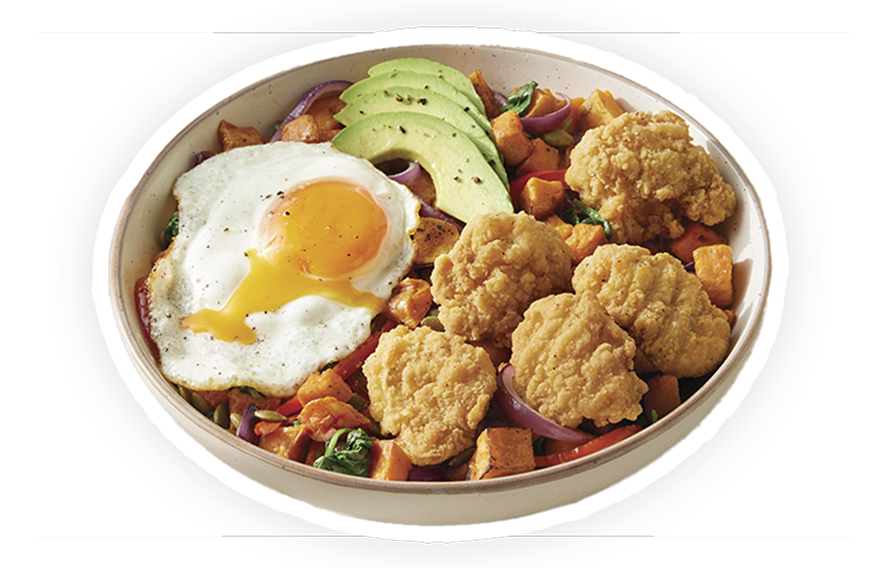 Chicken breast chunks in a bowl with sweet potato hash, avocado and a sunny-side-up egg