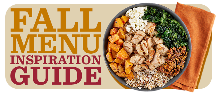 Overhead view of a bowl filled with rice, farro, squash, kale walnuts, goat cheese and chicken chunks