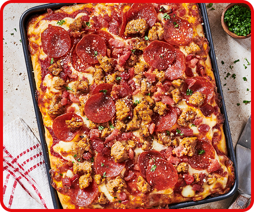 Fresh out of the oven pan pizza with melted cheese, pepperoni and bell peppers on a golden crust