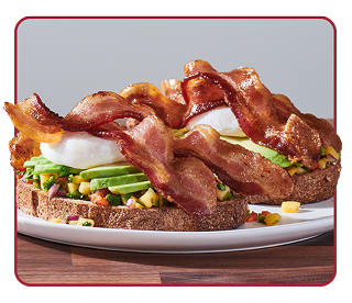 sandwich topped with Pico de Gallo, sliced avocado, bacon and an over-easy egg