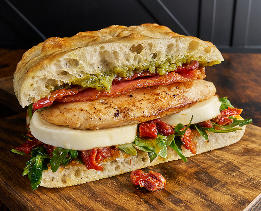 Chicken breast sandwich with focaccia bread, fresh mozzarella, bacon and other toppings