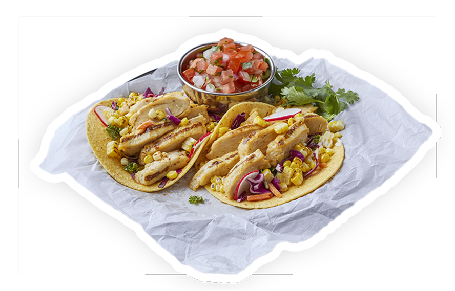 Two tacos on a napkin with grilled chicken spicy habanero, garlic, cilantro, lime juice and cheese