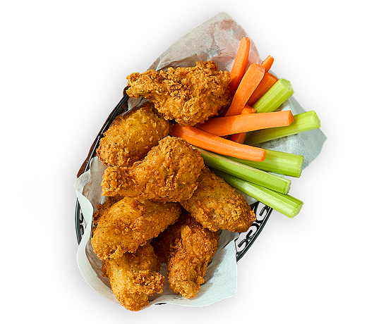 crispy fried chicken tenders in a paper-lined basket, served with fresh celery sticks and carrot sticks on the side
