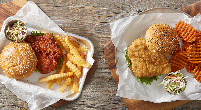 Two tempting chicken sandwiches, one spicy and one classic, with sides, ideal for diverse restaurant menus.