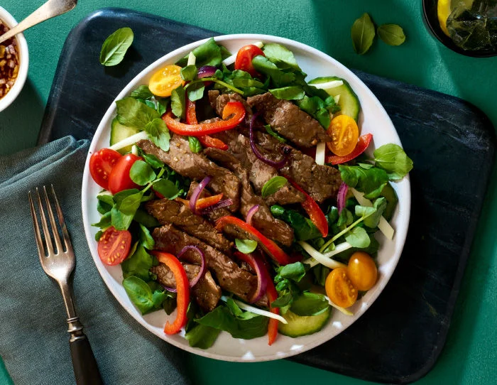 Vietnamese Shaking beef salad with beef peppers and salad
