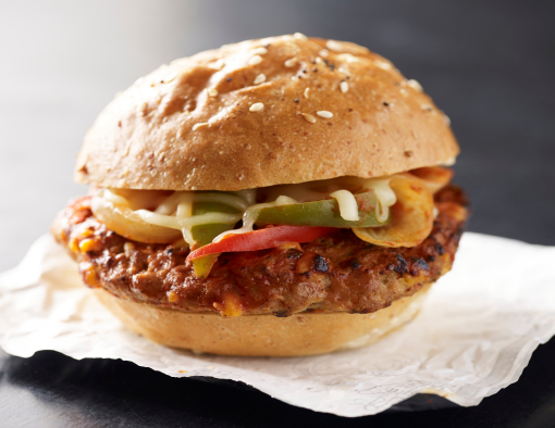 Meatloaf sandwich with cheese sauce, marinara sauce, peppers and onions served on a whole grain roll 