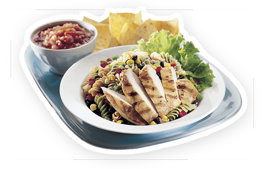 A chicken salad in a bowl with chips and dip