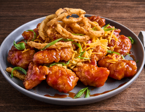 Whiskey BBQ Boneless Wings Recipe topped with crunchy fried onions