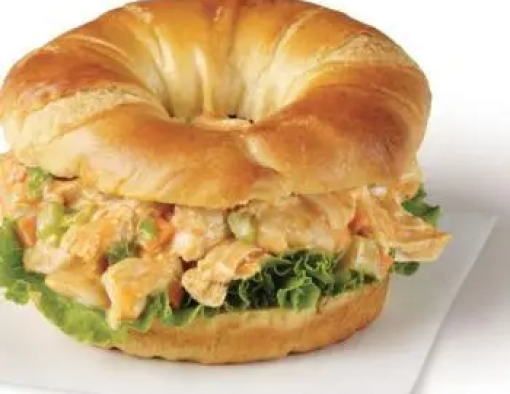A croissant stuffed with chicken salad and leaf lettuce 