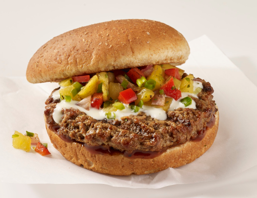 Grilled burger patty on bun topped with fire roasted pineapple Pico de Gallo sauce and melted queso cheese 