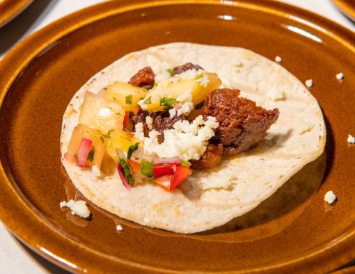 Tortilla with Pork Chorizo Crumbles, this delicacy is sauced with a sweet, spicy, and serrano pineapple salsa