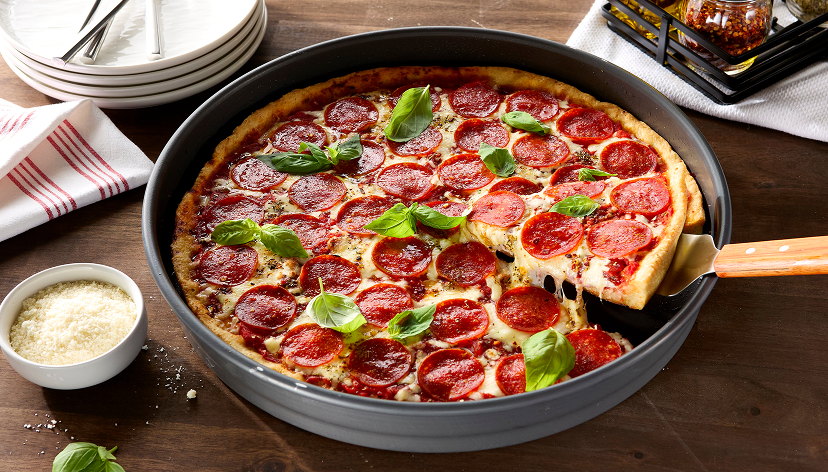 peperoni pizza in a pizza dish with a side of ranch