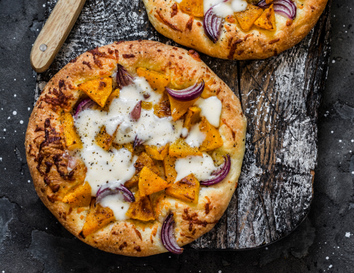 Hillshire Farm® Bakin' Bacon™ Heat-N-Serve Pizza Topping, shredded provolone/mozzarella blend roasted sweet potato, topped with arugula and a drizzle of balsamic vinegar