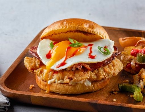 Breakfast Chicken Sandwich on a wood plate