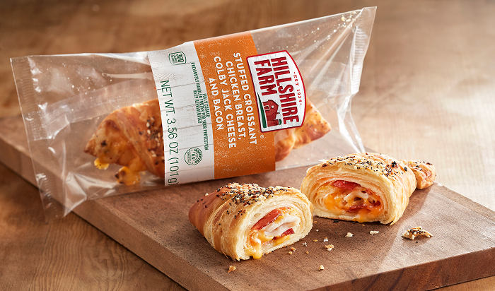 Hillshire Farm® Stuffed Croissant Chicken Breast, Colby Jack Cheese and Bacon product on cutting board