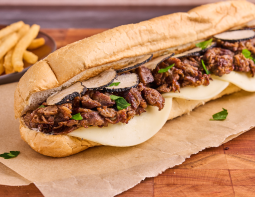 Shaved steak, truffle aioli, provolone cheese, and shaved black truffles served on a hoagie bun