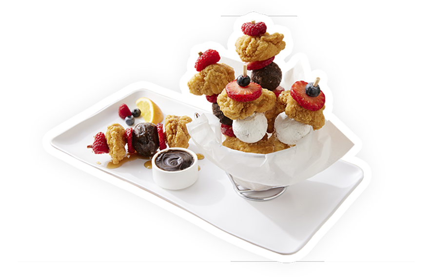 A selection of skewers featuring chicken breast chunks, donut holes and fresh fruit