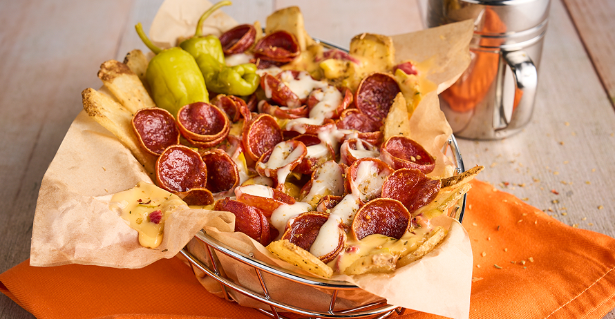 Fries topped with pepperoni, queso, and ranch dressing, served with pepperoncini peppers on the side