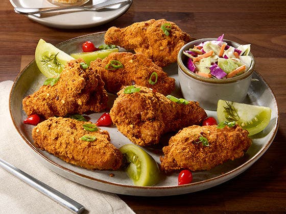Pimento cheese dry-rub coated crispy chicken wings pated with pickled green tomatoes and sweety drop peppers