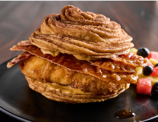 Crispy Chicken Breast filet with Hickory Smoked Bacon and a rich maple cinnamon butter spread all between a warm churro bun
