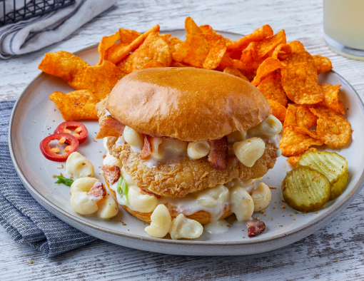 Mac 'N Cheese Breaded Chicken Sandwich with a side of chips