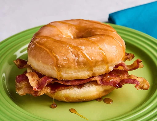 Apple Fritter Bacon Bliss Breakfast Sandwich with bacon, apple cider and brown sugar on an apple fritter