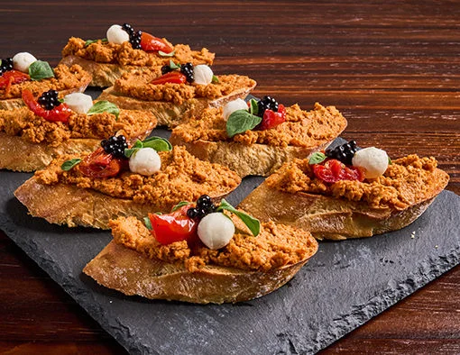 Pork Chorizo Crumbles paired with fresh mozzarella cheese pearls and roasted tomatoes