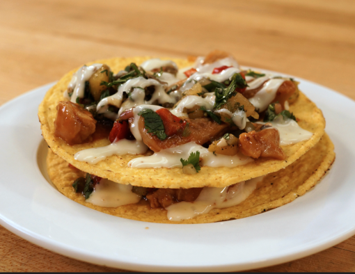 Grilled barbecue chicken strips with cheese sauce Pico de Gallo layered between two tostadas 