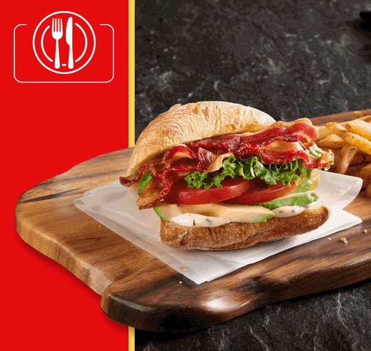 A selection of meaty sandwiches and pizzas, highlighting diverse ingredients and flavor