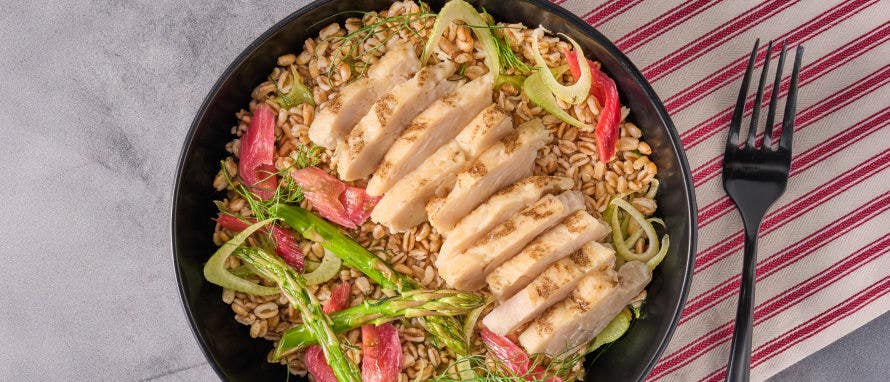 Bowl with rice topped with sliced chicken