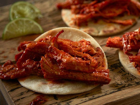 Tequila Braised Pork Carnitas with a sliced lime on the side.