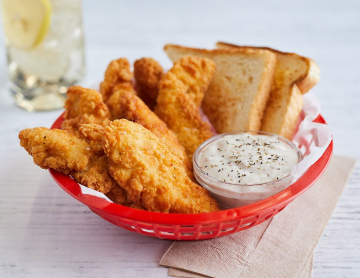 Homestyle select cut chicken tender fritters on toast with pickles and hot sauce