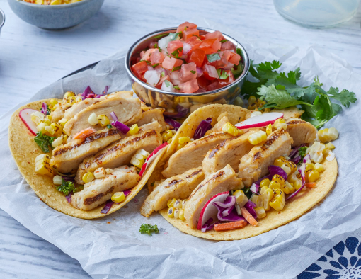 Chicken Street Tacos on a plate with a side of pico de gallo