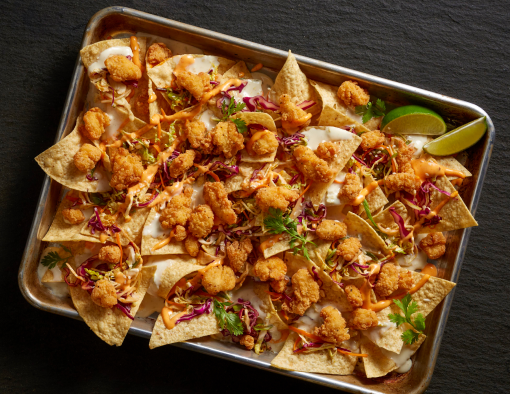 Lightly breaded Tyson® Mini Chicken Bites on Korean-Inspired Chicken Nachos