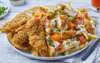 Loaded fries topped with crispy chicken, bacon, cheese curds, and a creamy sauce