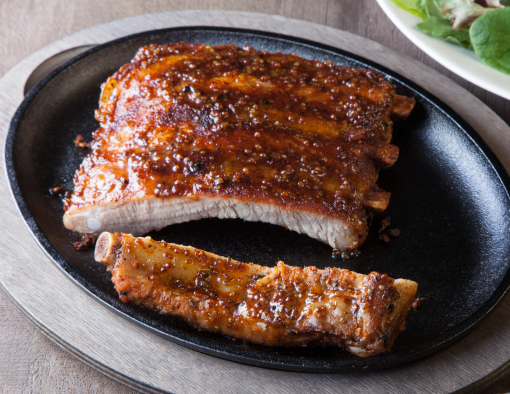 Braised Beef Short Ribs on a black plate