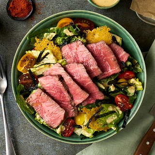 Boneless tenderloin sliced and on top of a salad