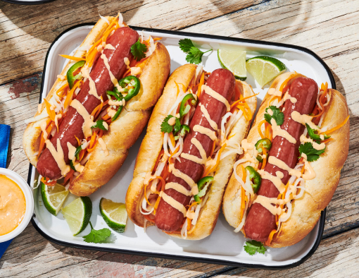 Bánh Mì Dog topped with pickled carrot and daikon drizzled with sriracha mayo