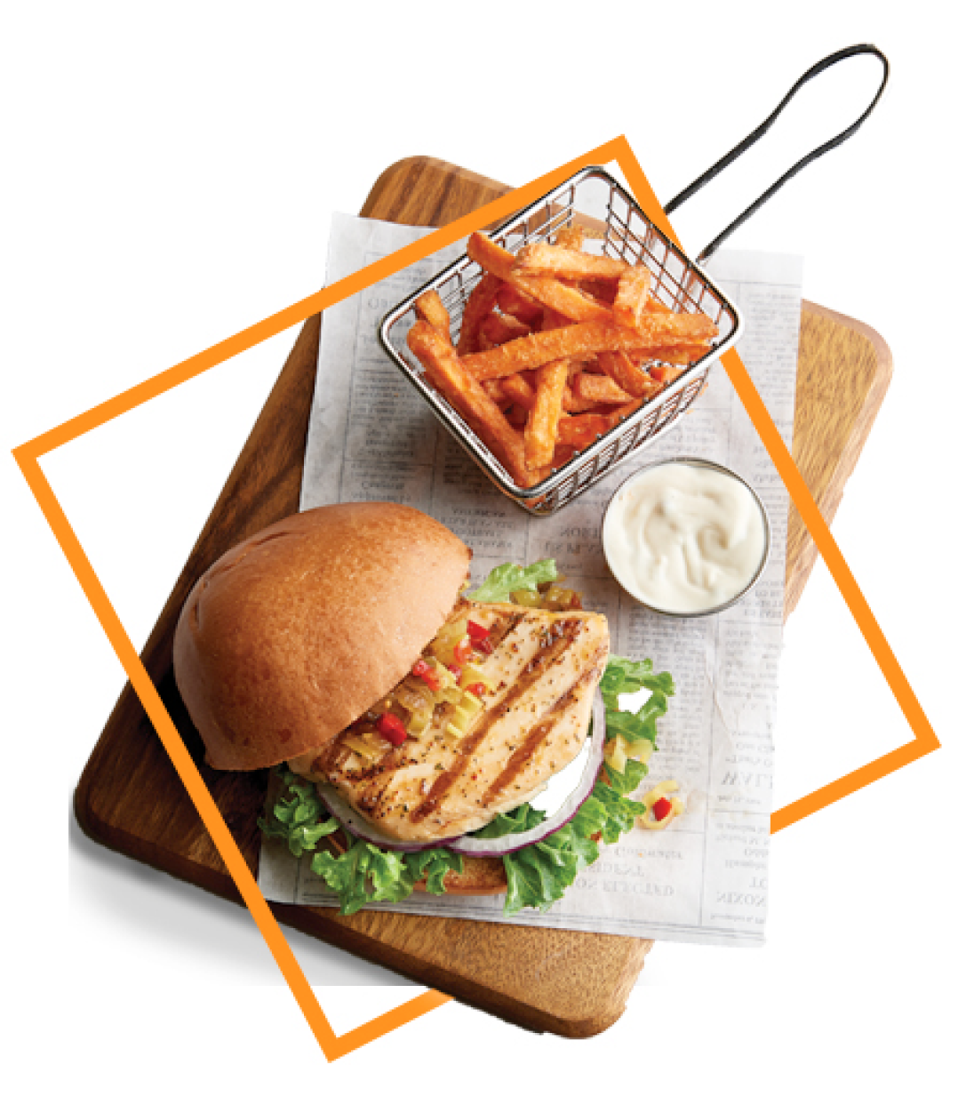 Grilled chicken sandwich with a side of fries on a cutting board