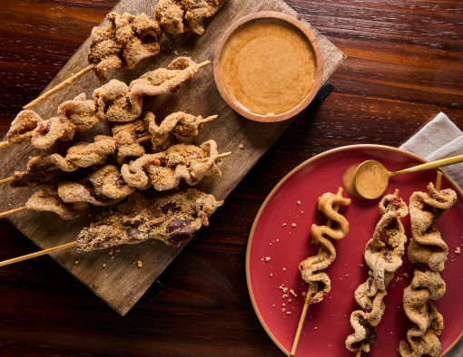 Applewood Smoked Bacon are folded onto a stick, dipped in seasoned batter and deep-fried to crispy perfection