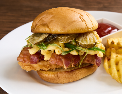 Chicken Bacon Mac Sandwich with a side of fries and ketchup on a white plate