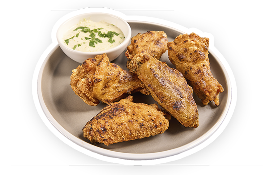 Wings and dipping sauce on a plate