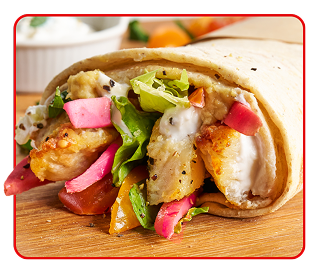 An open-ended grilled chicken wrap overflowing with a variety of ingredients