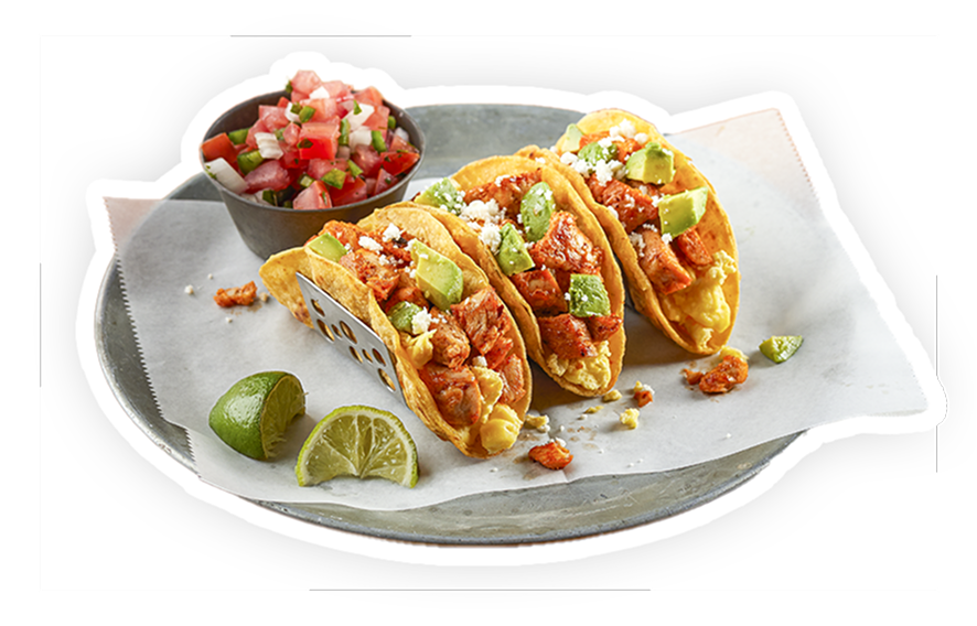 A trio of chicken tacos on a plate with egg, salsa and avocado