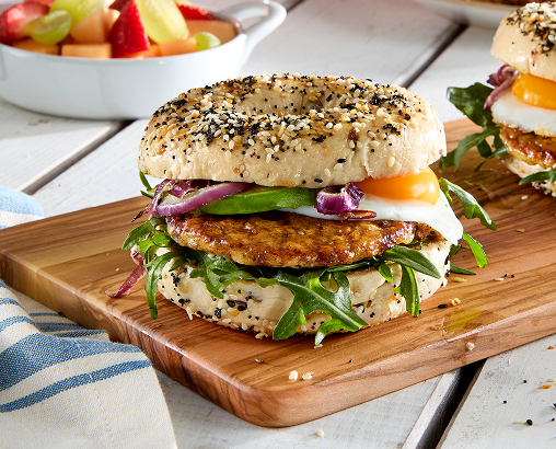 Everything bagel with sausage, egg and avocado in between