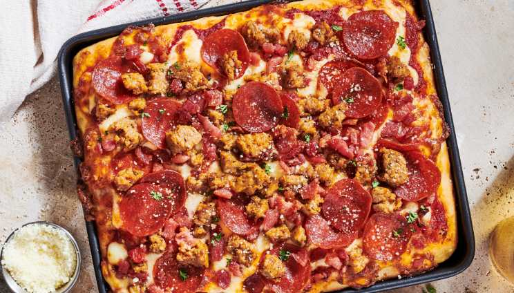 meatlovers pizza in a black pan