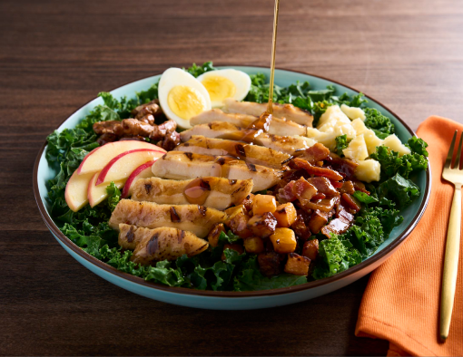 Chicken Maple Bacon Chop Salad topped with walnuts, hard boiled egg, apples and fresh kale