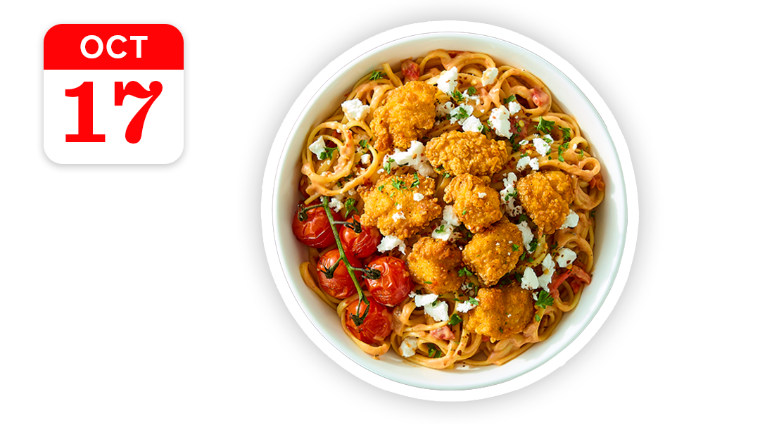 A bowl of pasta with crispy chicken, cherry tomatoes, and feta cheese, with a calendar icon for October 17