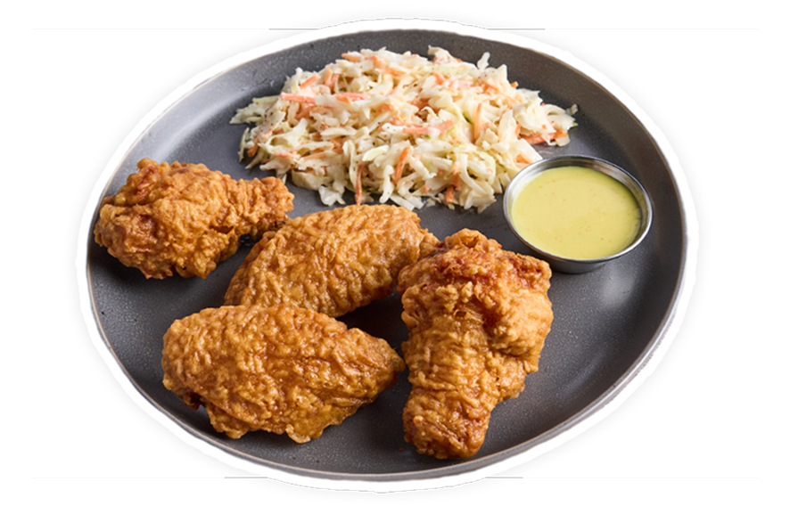 Chicken wings with a side of slaw and sauce